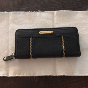 A slightly used black leather large zipper Michael kids wallet
